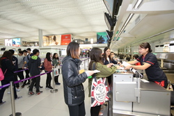 In the terminals, airport staff deploys crowd management contingency measures to assist role-playing passengers waiting at check-in aisles.